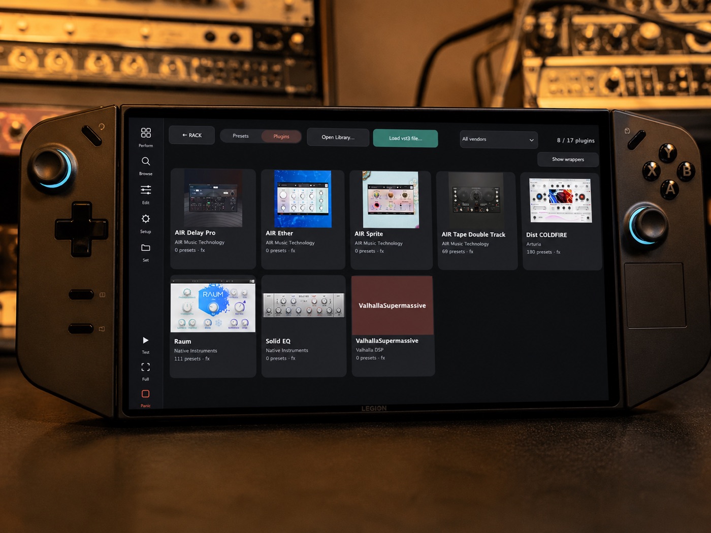 Pomar Rack running on a Lenovo Legion Go handheld — the plugin browser on its touchscreen — on a desk in front of rack gear and synths.